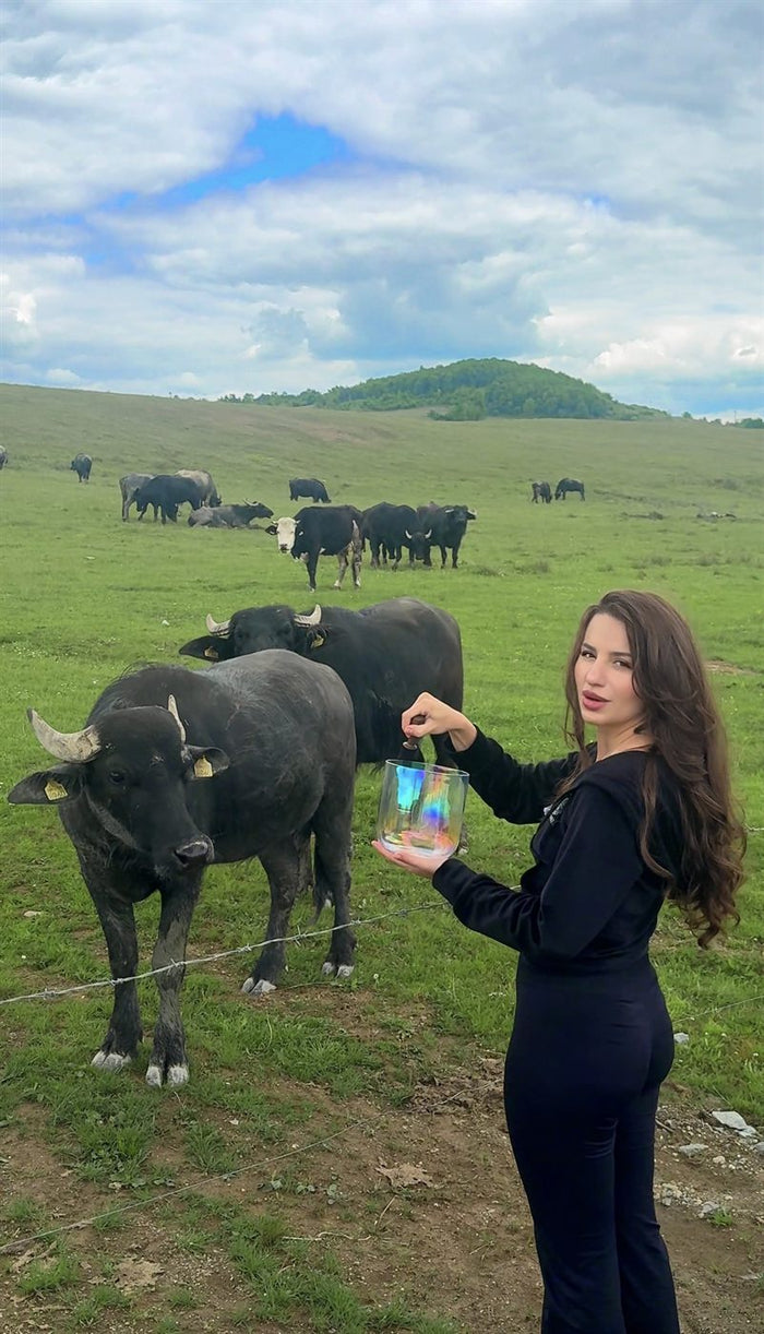 Xenia singing outdoors, among animals