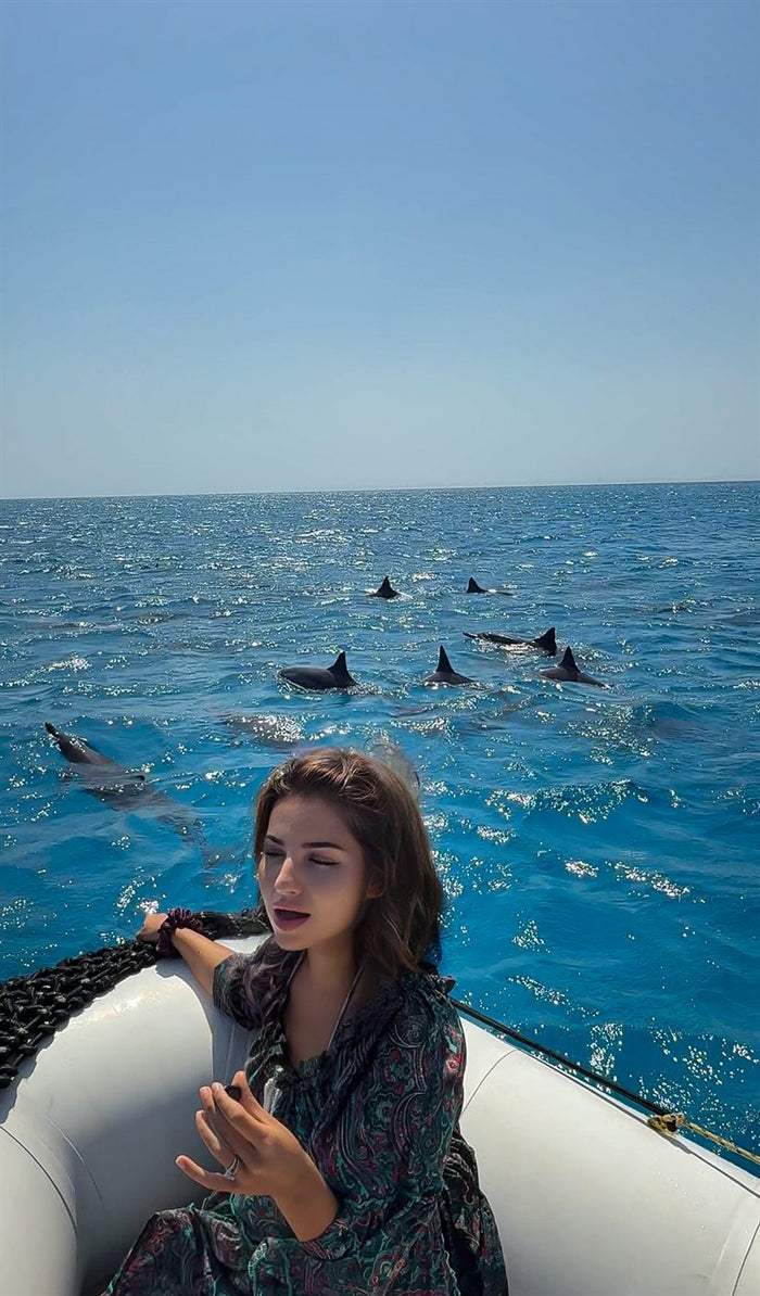 Xenia singing outdoors, among animals
