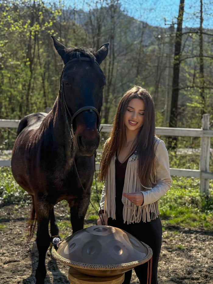 Xenia singing outdoors, among animals